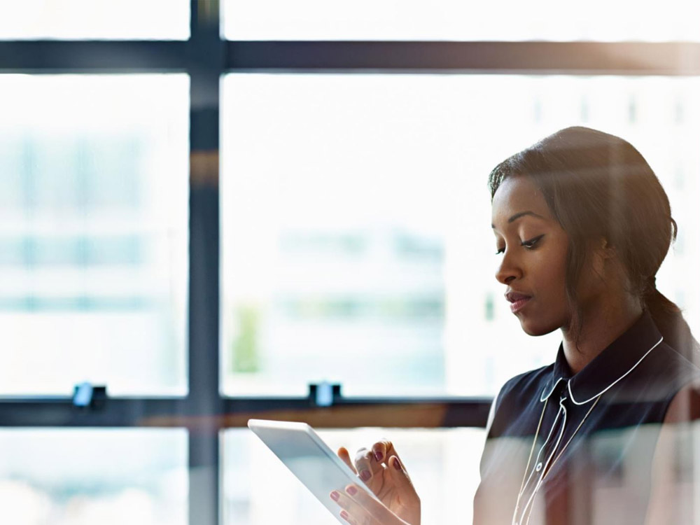 a woman reviewing her tablet