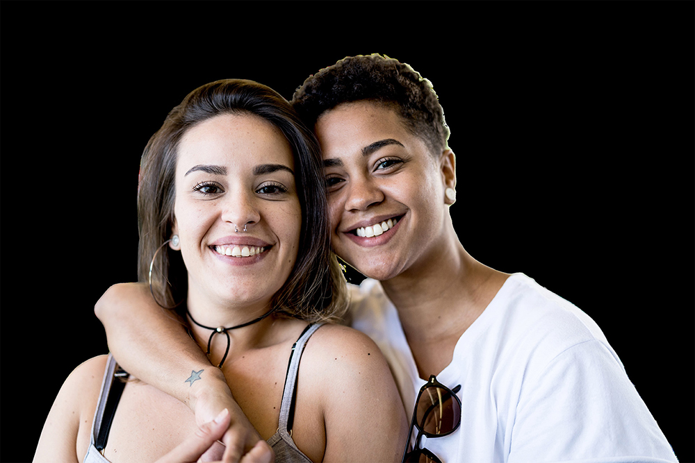 two people standing close together and facing the camera