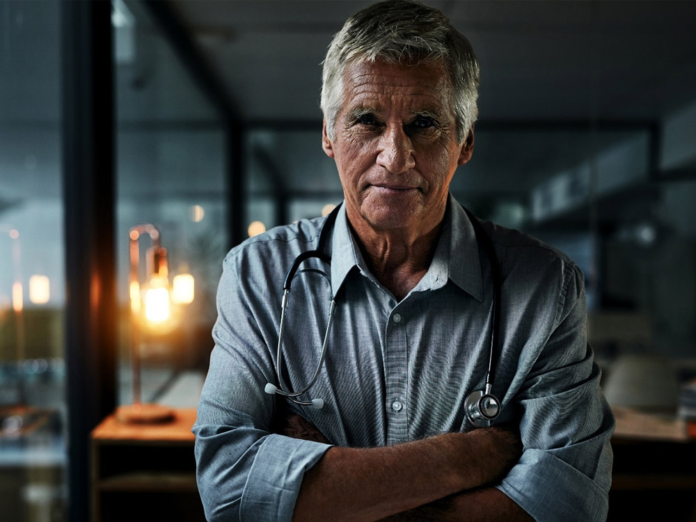 a provider with a stethoscope stands in front of a window