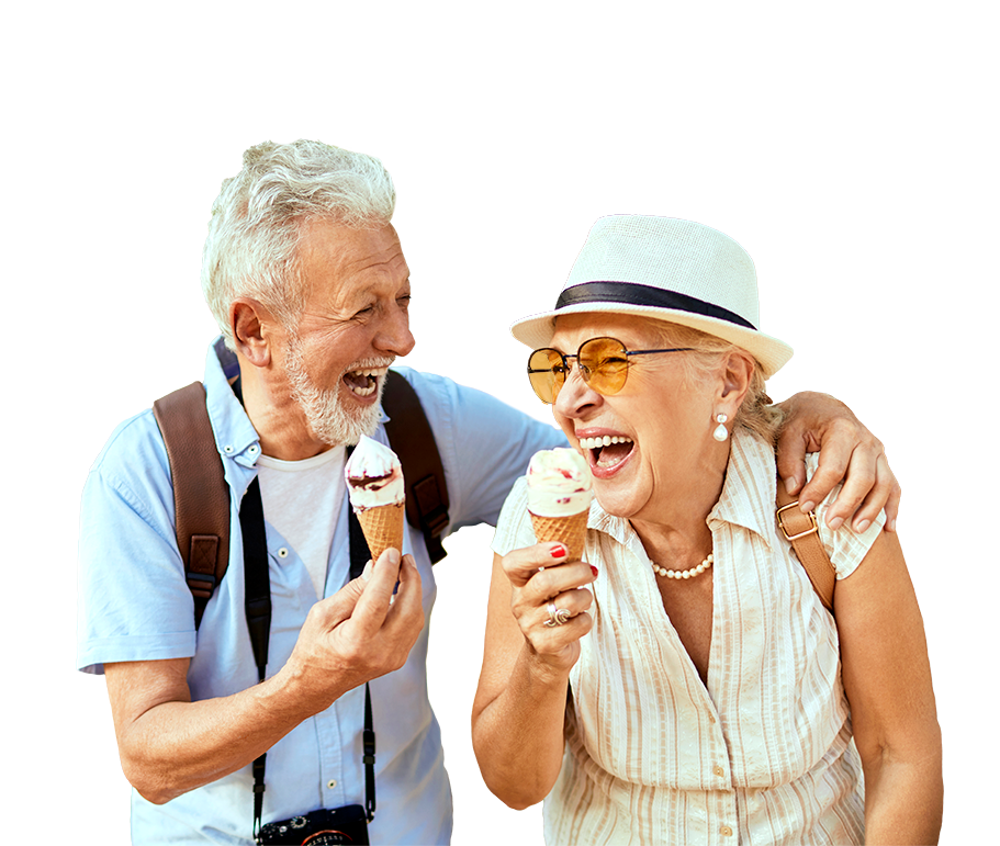 Two people smiling while eating ice cream cones