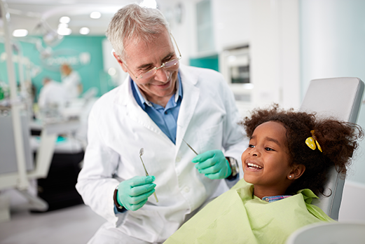 Dentist with child in dental chair