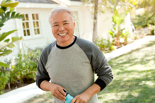 Man smiling standing in front yard