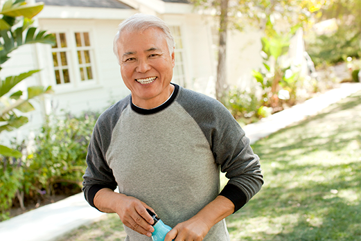 163316-5NewToMedicare-521x348 Man smiling standing in front yard