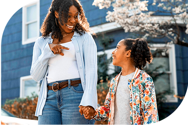 Mother and daughter walking hand in hand.