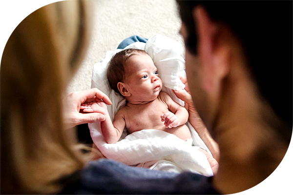 Parents comfort a tiny newborn baby