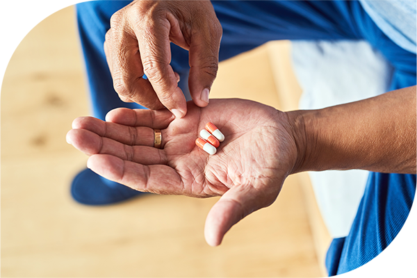Close-up of a hand holding multiple pills.