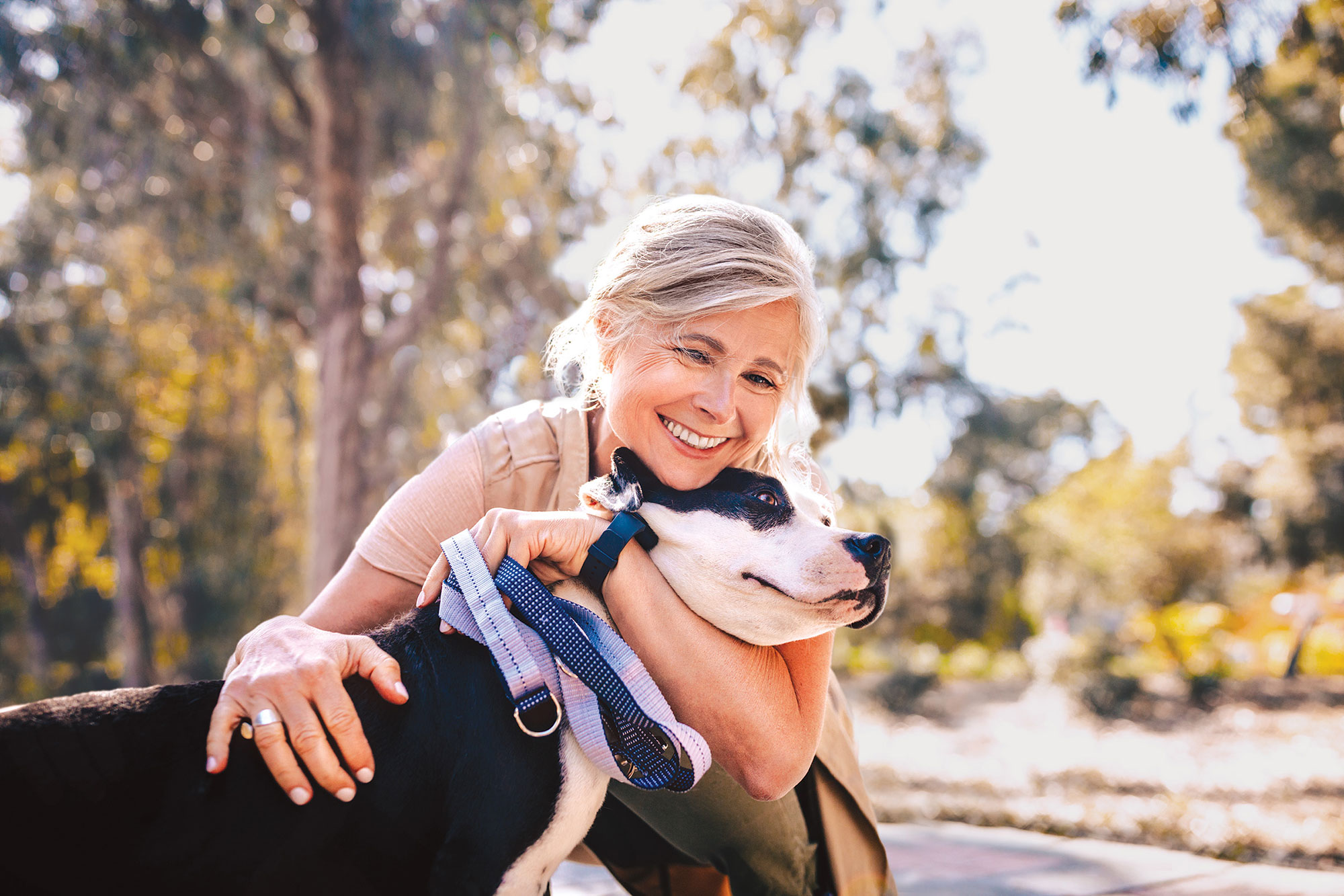 woman hugging a dog outdoors