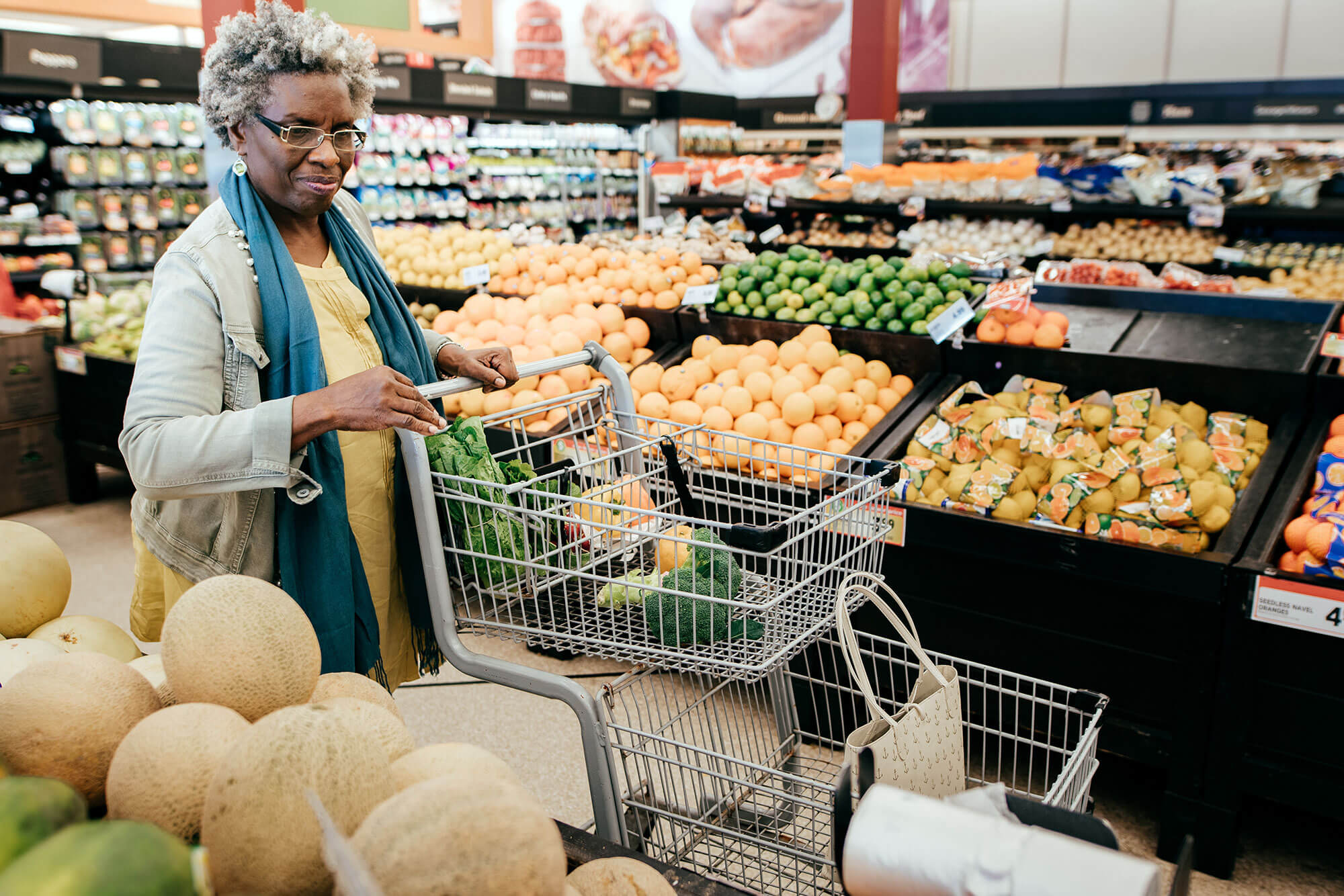 older woman buying healthy foods in a grocery store