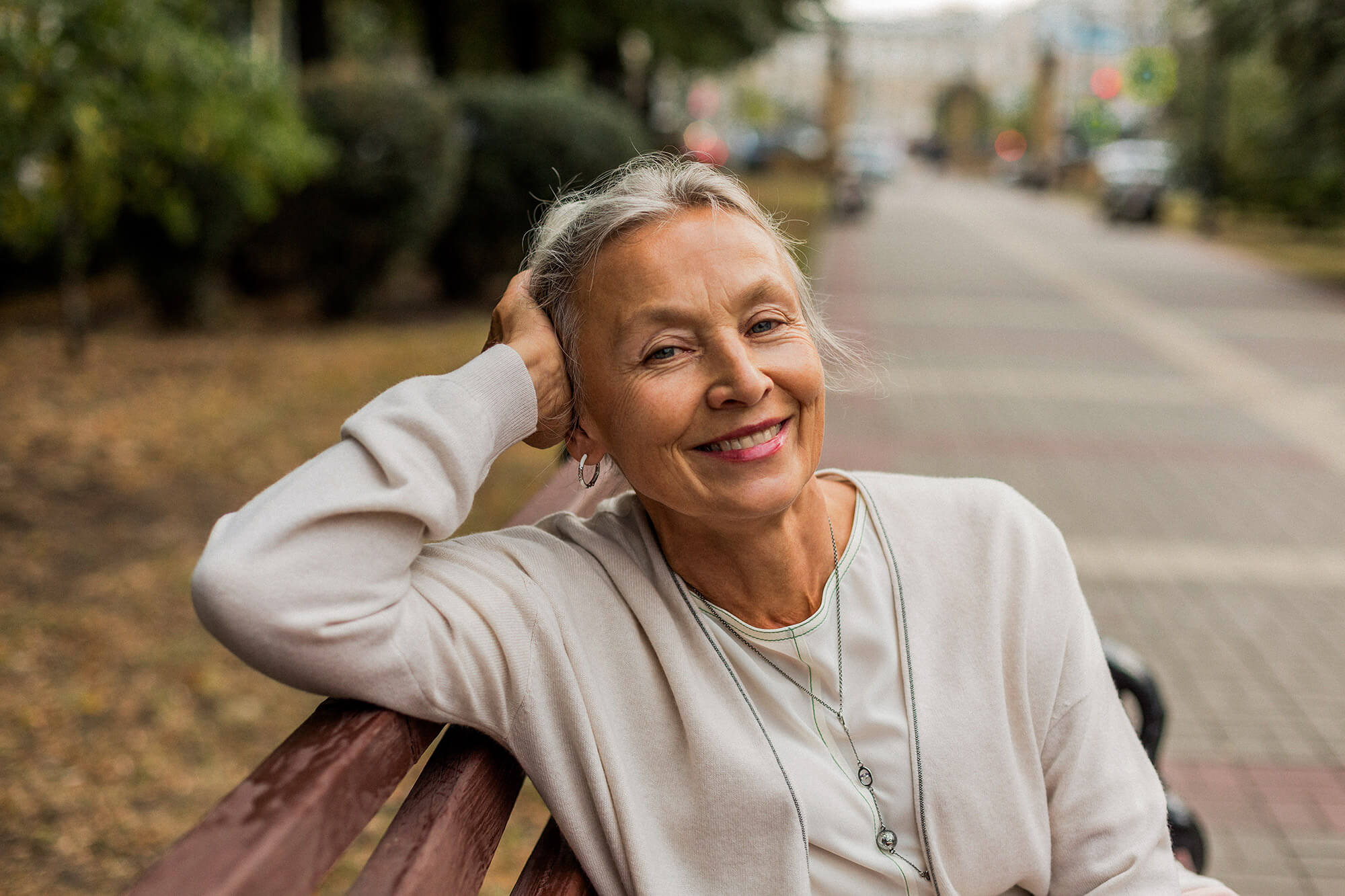 a woman sitting on a park bench