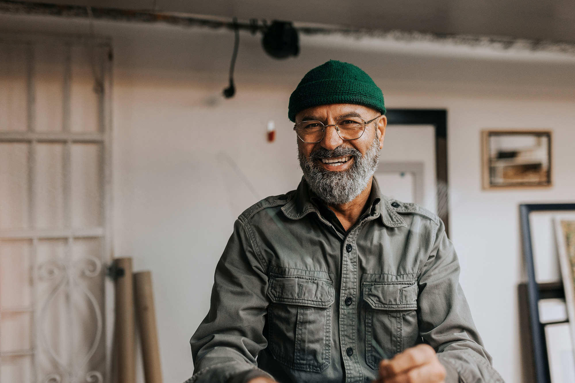 Smiling bearded man in a green hat