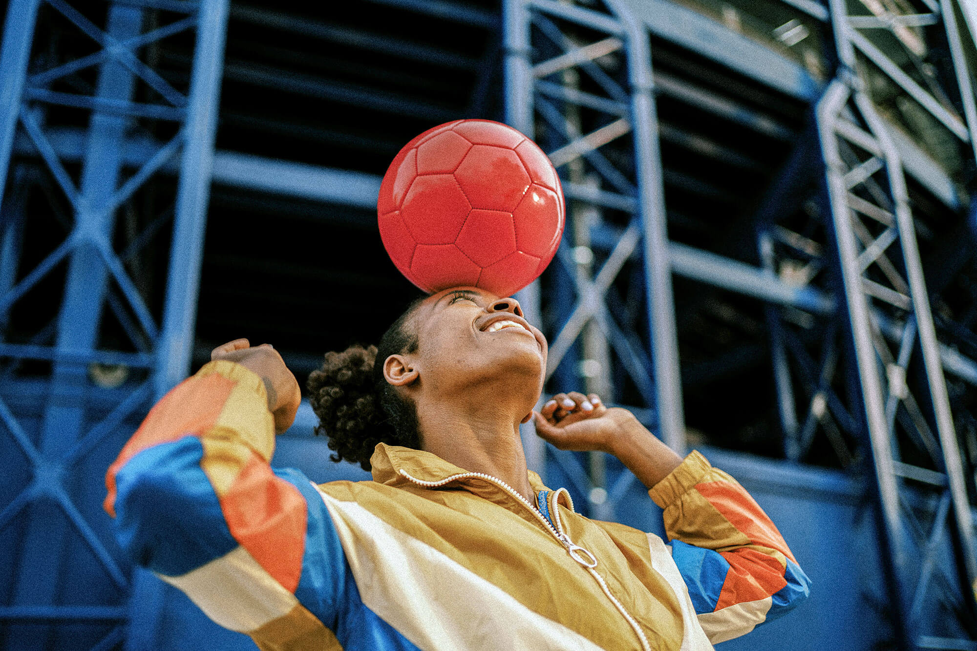 a woman balancing a soccer ball on her head