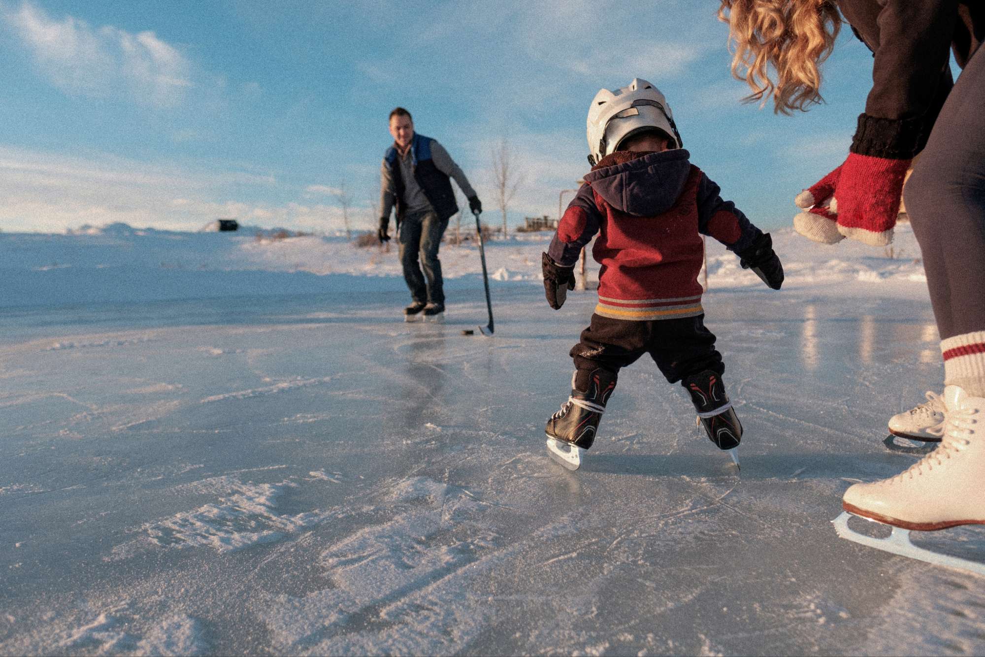 child health plus toddler learning to play hockey with parents