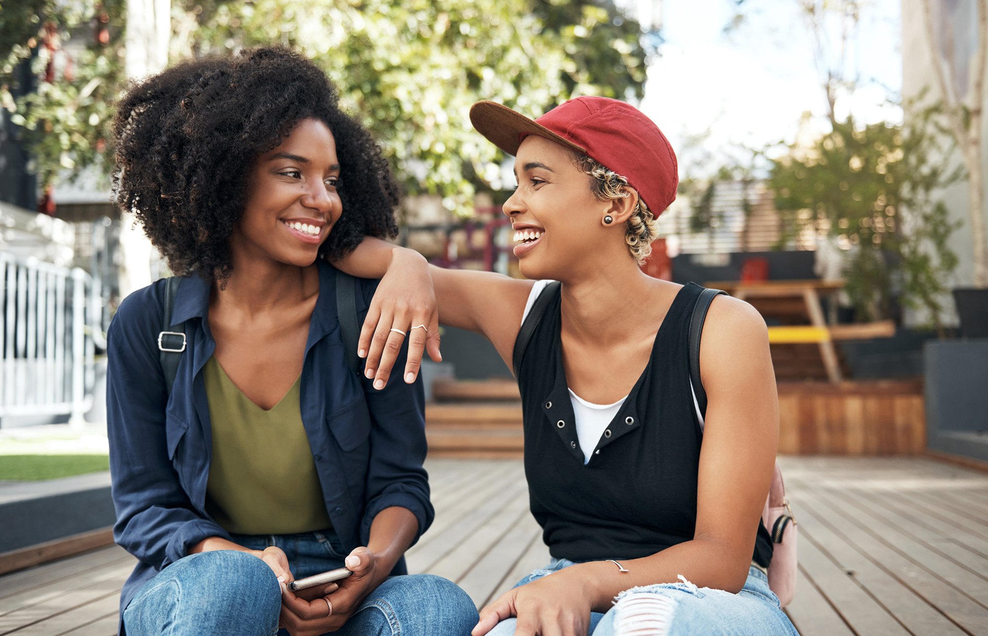 two young women smiling on outdoor deck