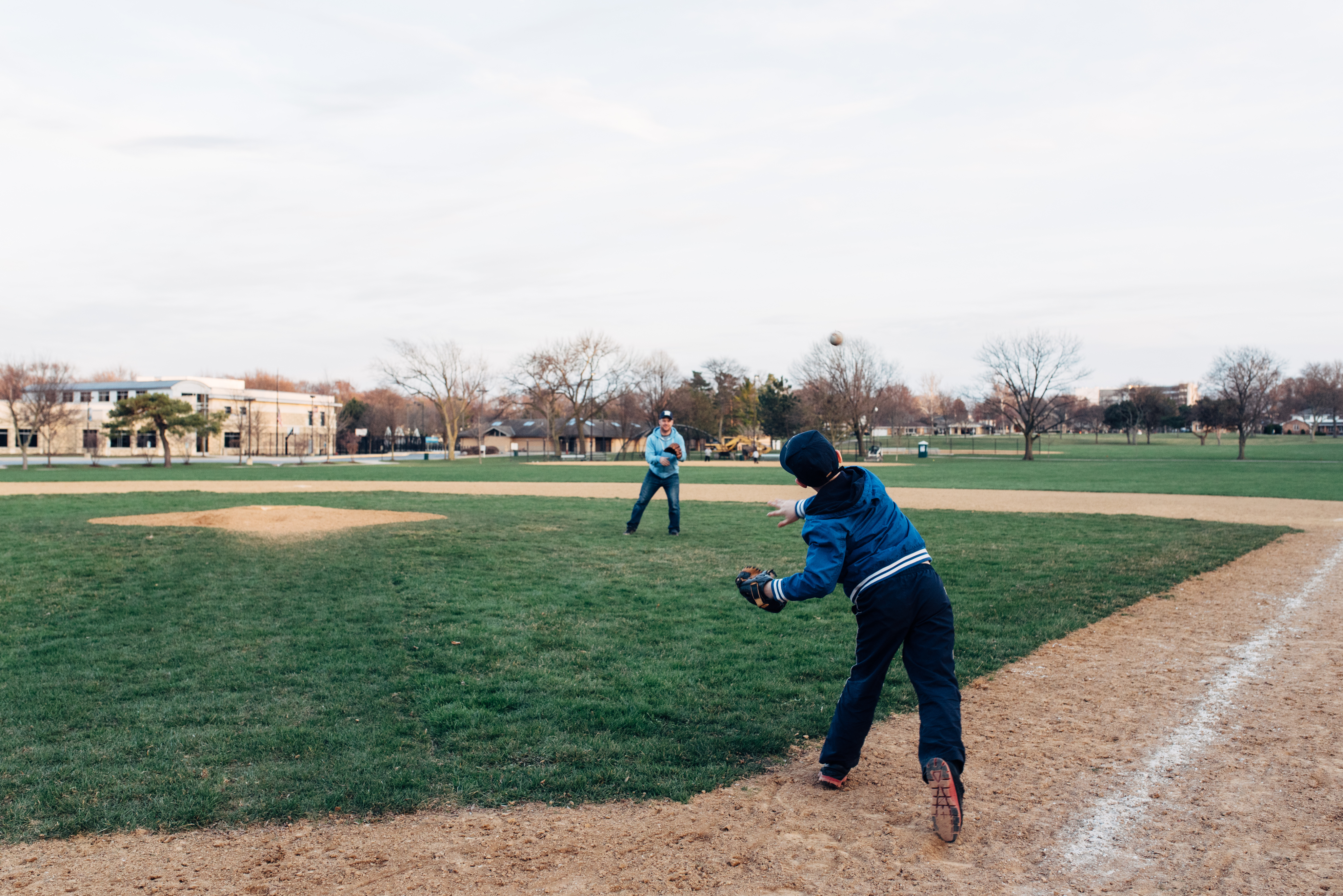 kid and dad playing baseball