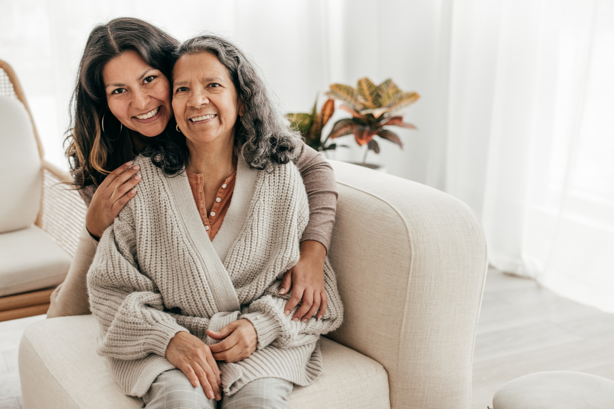 mother daughter hugging on couch