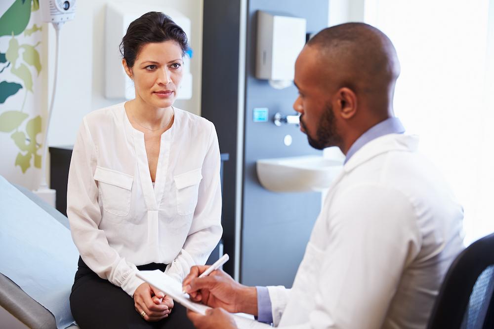 doctor recording information from patient