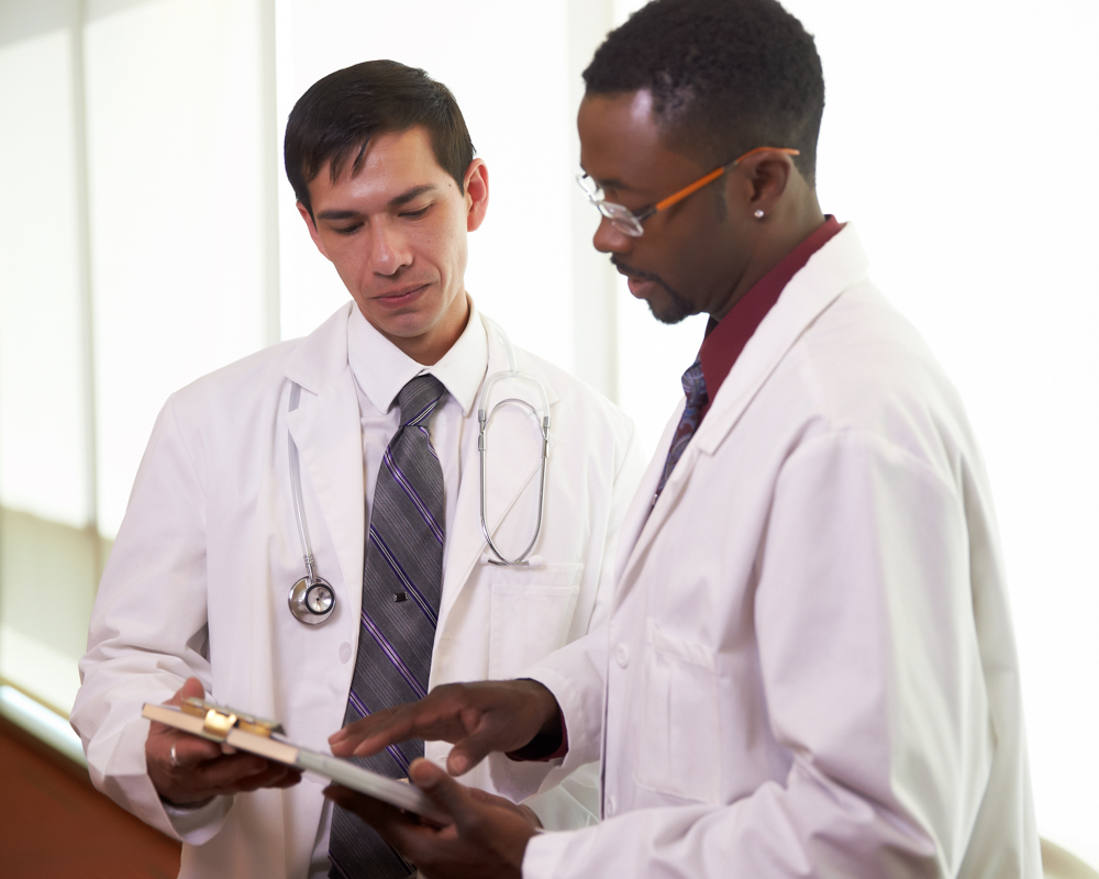 doctors-reviewing-chart-together doctors reviewing chart together