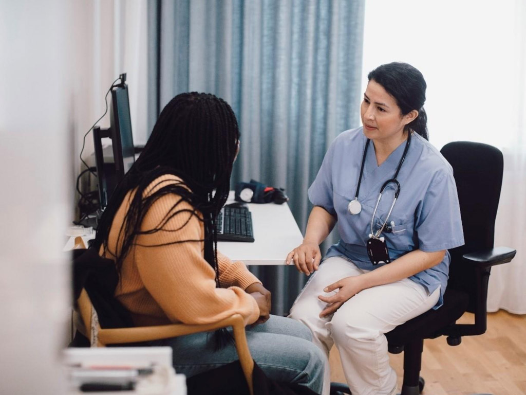 a female doctor discussing health concerns with a patient in a medical office