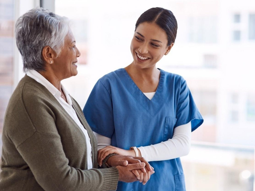 a nurse and an elderly patient engaged in a conversation