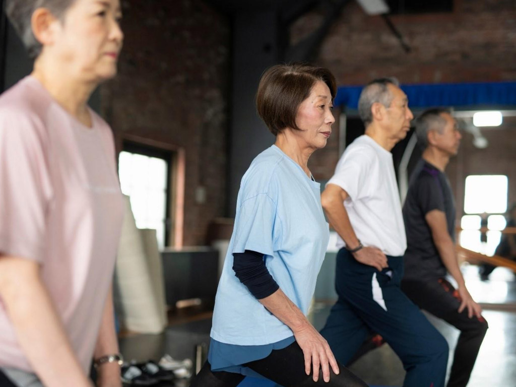 elderly individuals exercising together in a gym