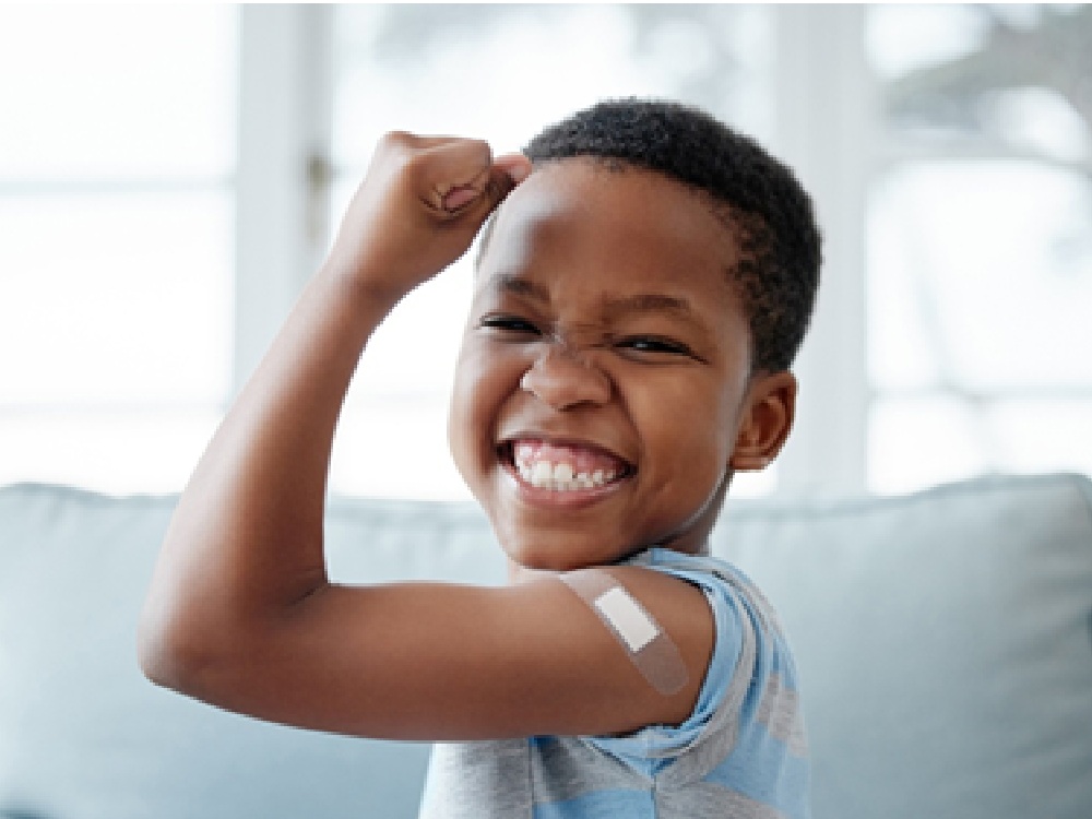 kid flexing after shot