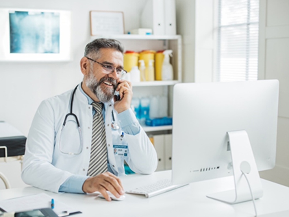 provider on phone at desk