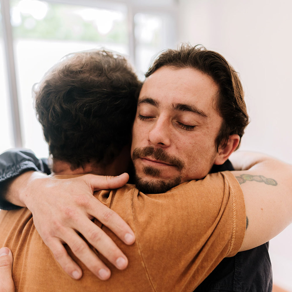 two men hugging it out