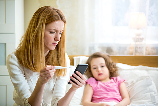 mom taking child's temperature