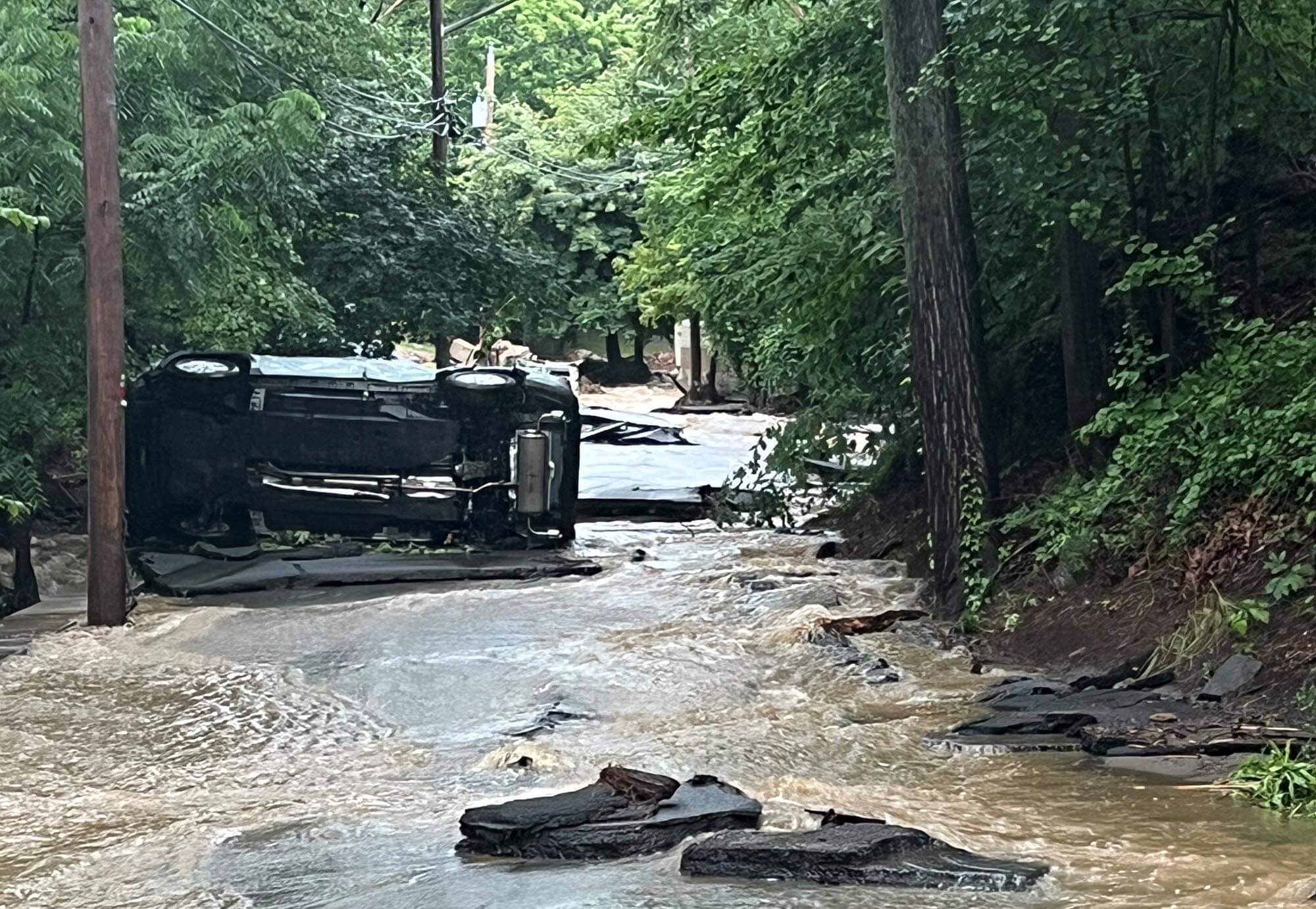 overturned-car-on-flooded-road overturned-car-on-flooded-road